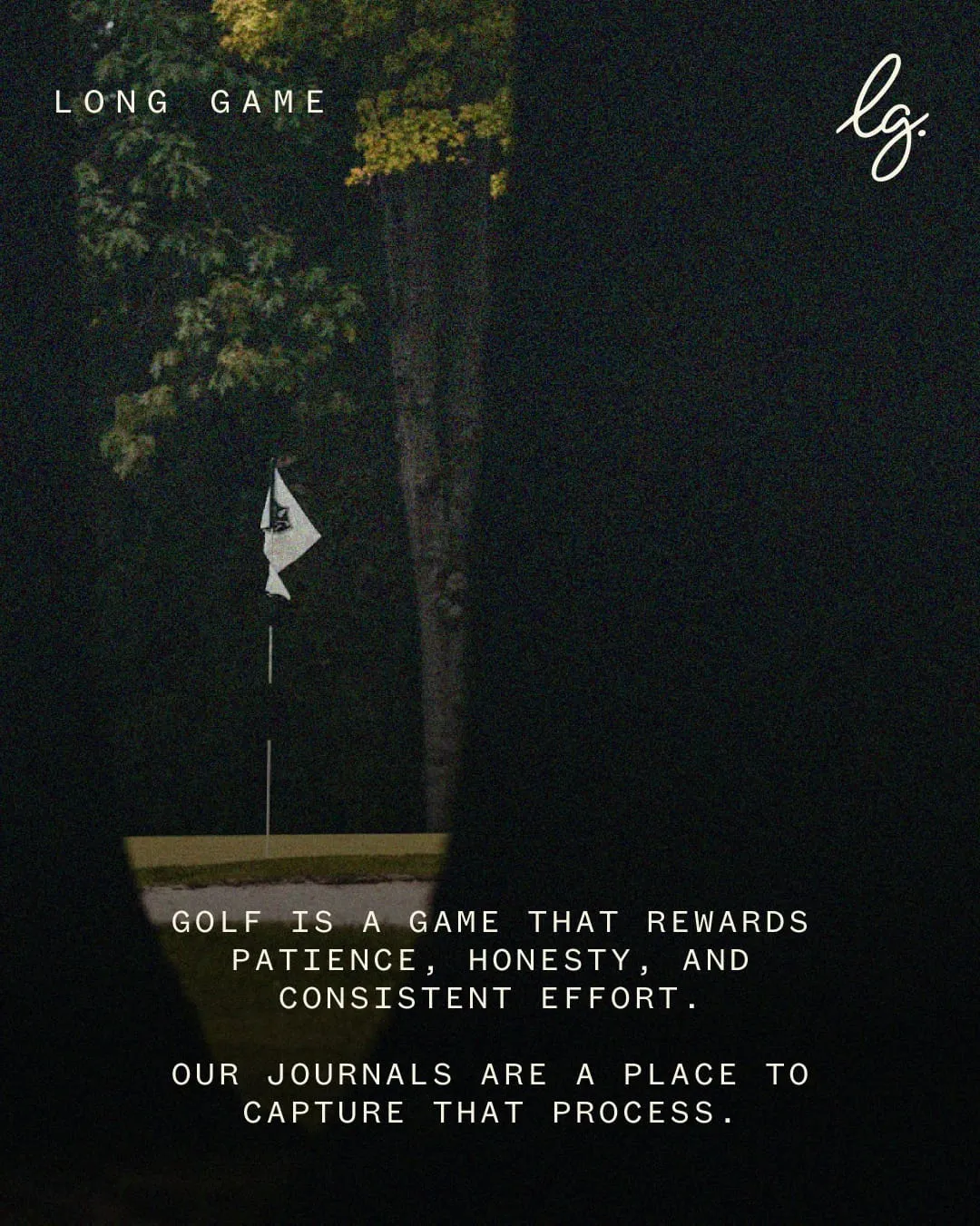 A flag on a quiet green at dusk, framed by trees.